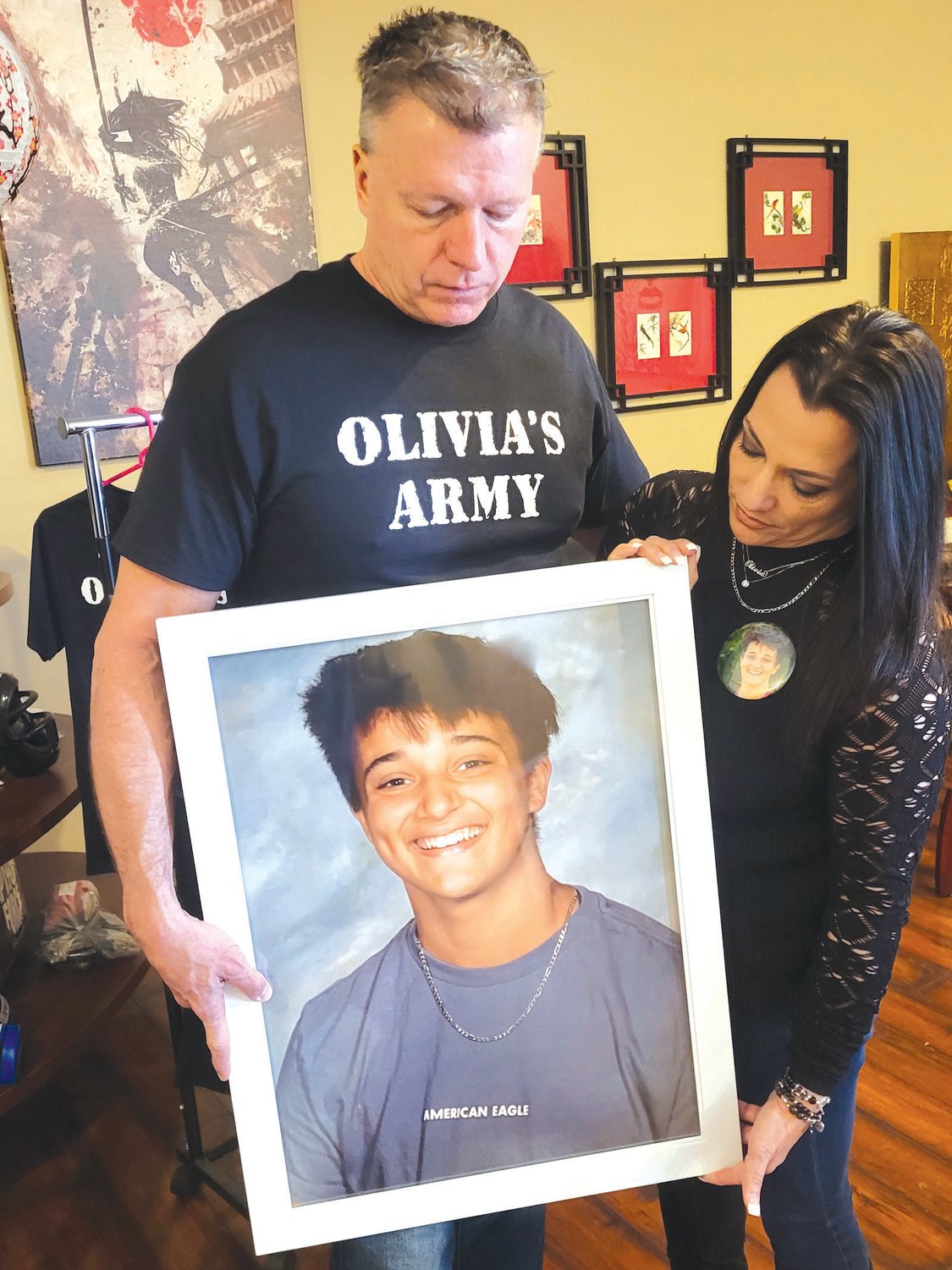 JUSTICE FOR OLIVIA: Dennis Molloy and Janine Passaretti-Molloy hold a portrait of their daughter, Olivia, who was killed in a crash on New Year’s Eve.